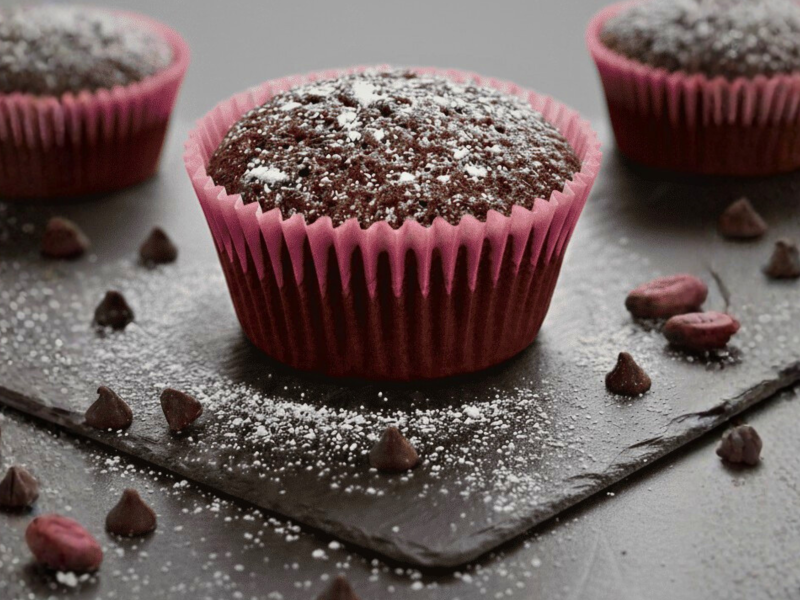 מאפינס שוקולד בתוך מנג'טים ורודים עם שוקולד צ'יפס על גבי מגש שחור